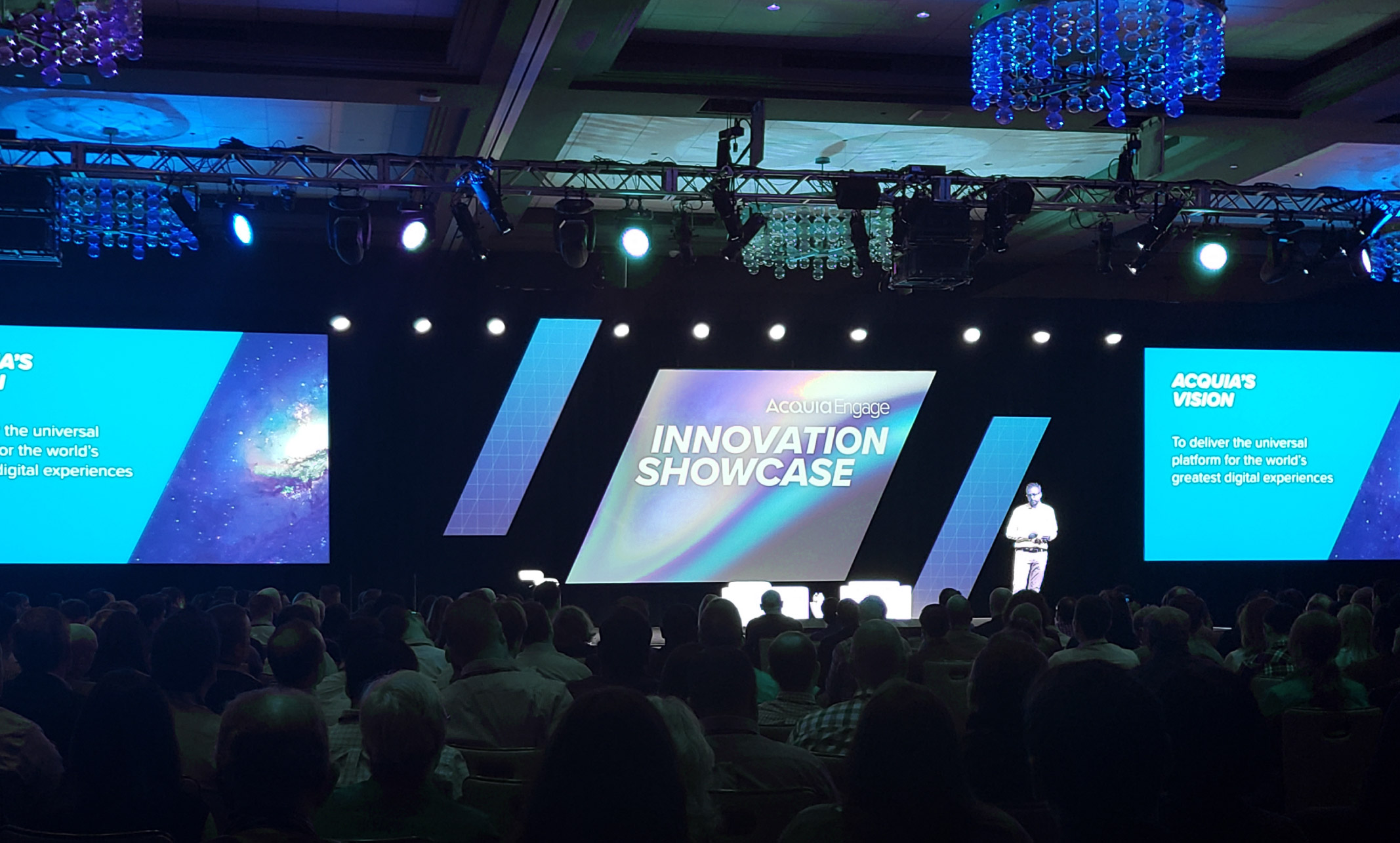 The stage during Acquia Engage Innovation Showcase with a keynote speaker in front of the crowd