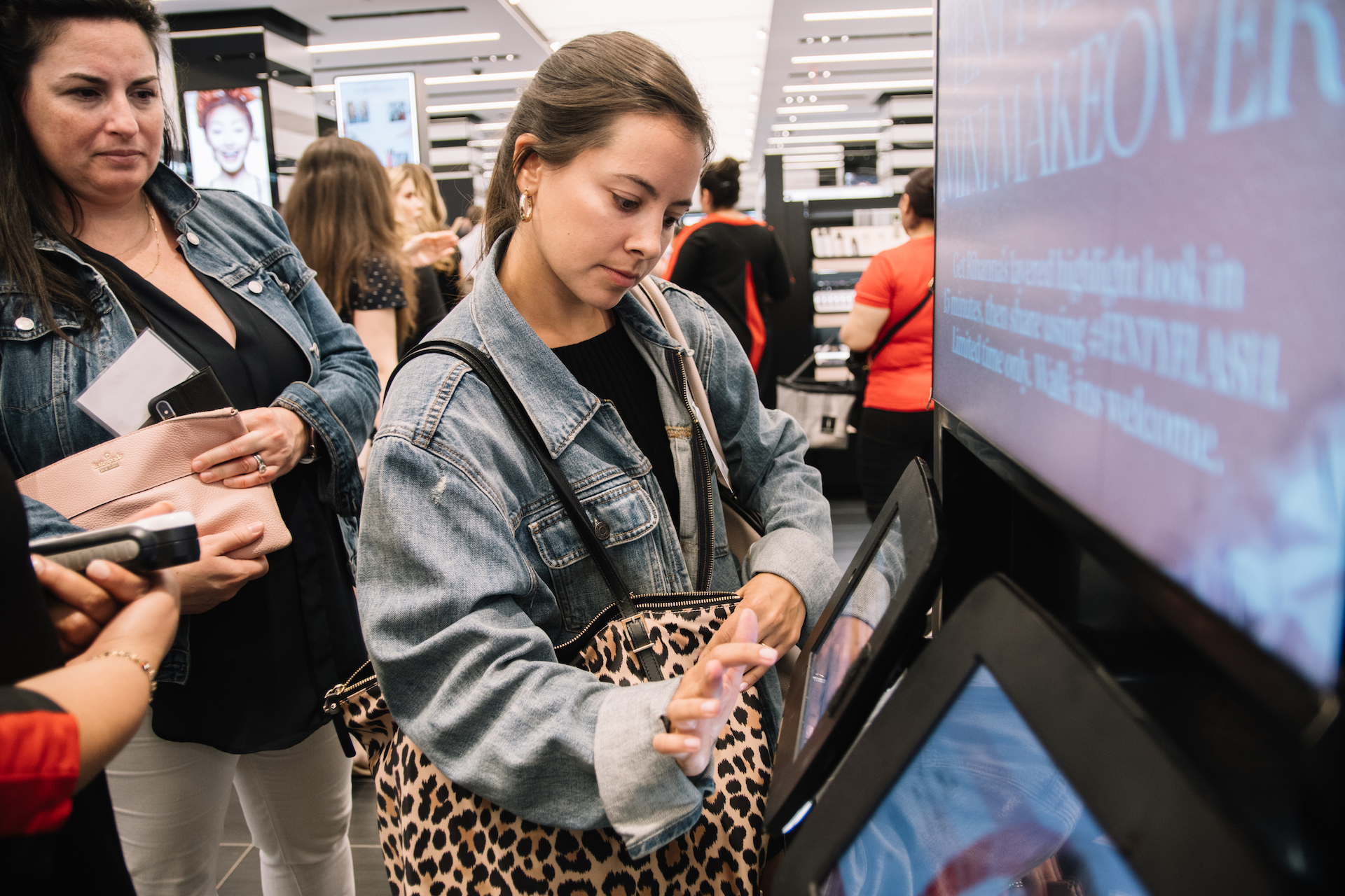Two women using digital personalization kiosk at Sephora